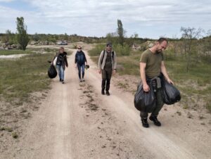 Волонтери несуть мішки зі сміттям стежкою під час еко-походу навколо Арбузинського каньйону